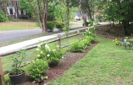 Front of the house split post fence and flower patch