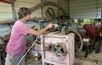Ben fixing up his grandfather's seed cleaner. 