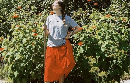Emma standing by plants