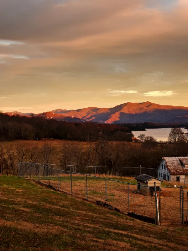 Farm and farmhouse with hills in the background