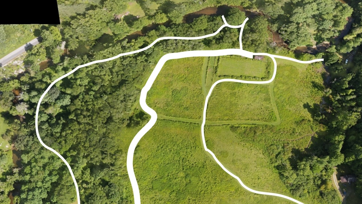 Up to two acres for vegetable or flower cultivation using organic methods. The existing building for tool storage and light processing is visible in the upper right of the aerial photo.