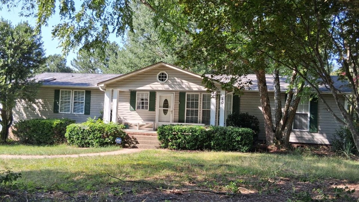 Manufactured home on permanent foundation with permanent front and back porches.