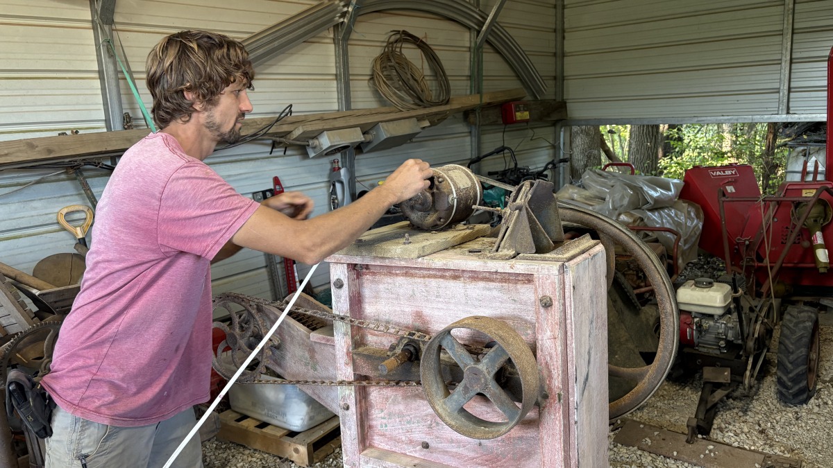 Ben fixing up his grandfather's seed cleaner. 