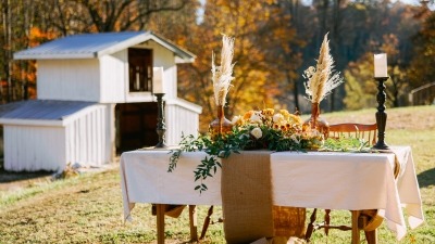 Wedding table setup in cleared area next to the barn