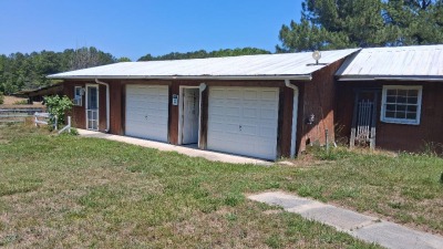 two garage doors with remotes one more manual garage in the back