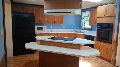 kitchen island with cooktop, eat-at bar and prep area.