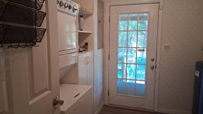 Large laundry room accommodates a full size washer and dryer.  The stackable set shown here has been removed.