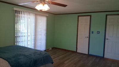 primary bedroom with sliding doors opening onto back porch