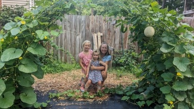 Family under trellised cantaloupes 2024