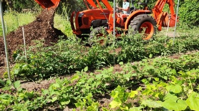 Kelli moving mulch for pathways