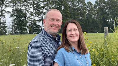 Portrait headshot in foreground with rural scenic background