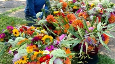 Me smiling with harvested flower arrangements