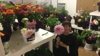 Me smiling in a flower cooler room