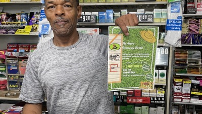 A community holding a flier advertising our community garden