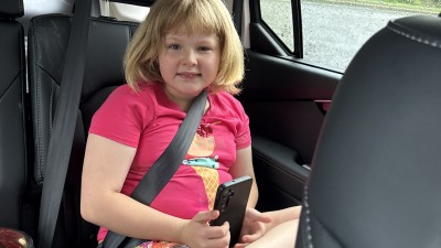 Eight year old smiling in the car