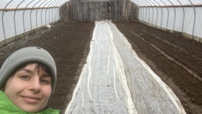 Me smiling after preparing garden beds in a hoop house