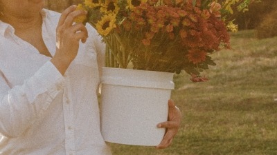 holding a bucket of flowers