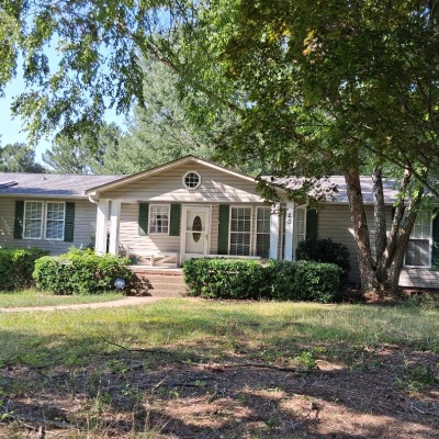 Manufactured home on permanent foundation with permanent front and back porches.