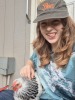 Me sitting on the front of a shed with a chicken on my lap