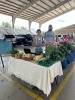 This shows me and my partner selling our produce at our local farmers market. 