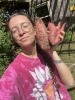 Emma holding sweet potatoes they grew. 