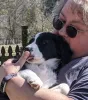 Woman farmer, Stacy Martin, with an English Shepherd puppy.